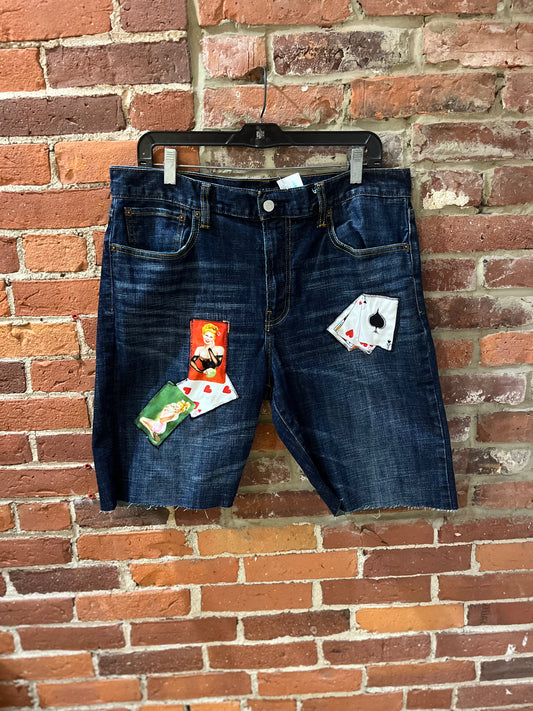 Upcycled patch of cards cutoffs